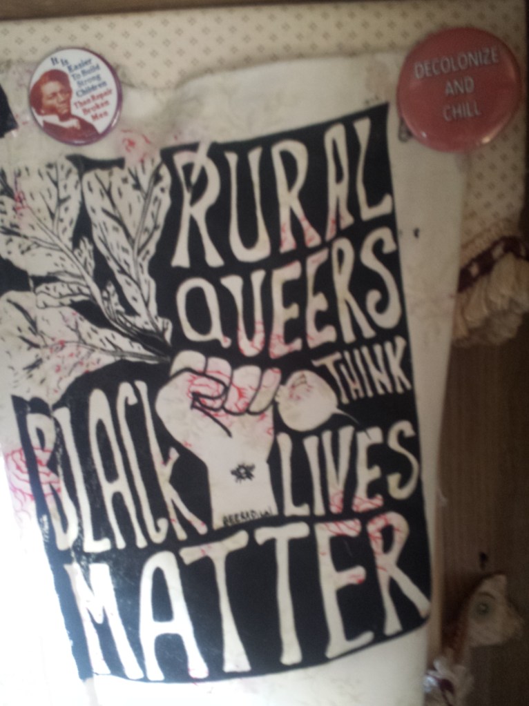 rural queer think black lives matter screen print on rose pattern material with a fist holding a radish