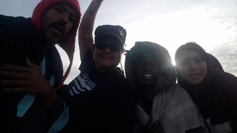 4 organizers bundled up with a shiny, blue sky in the background